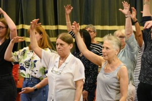 Photo of members of the choir warming up